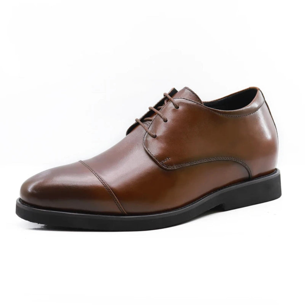Brown leather dress shoe on a white background