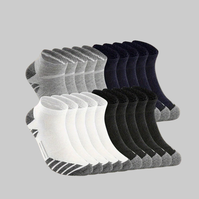 Set of gray, black, and white ankle socks on a beige background